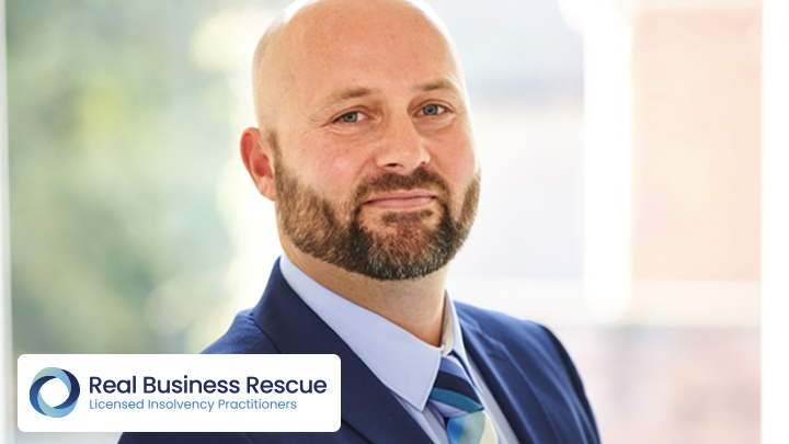 Man smiling with Real Business Rescue logo in corner