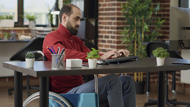 man typing on computer keyboard