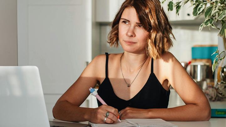 woman writing at laptop