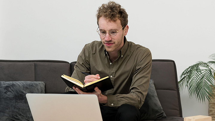 Man writing in book